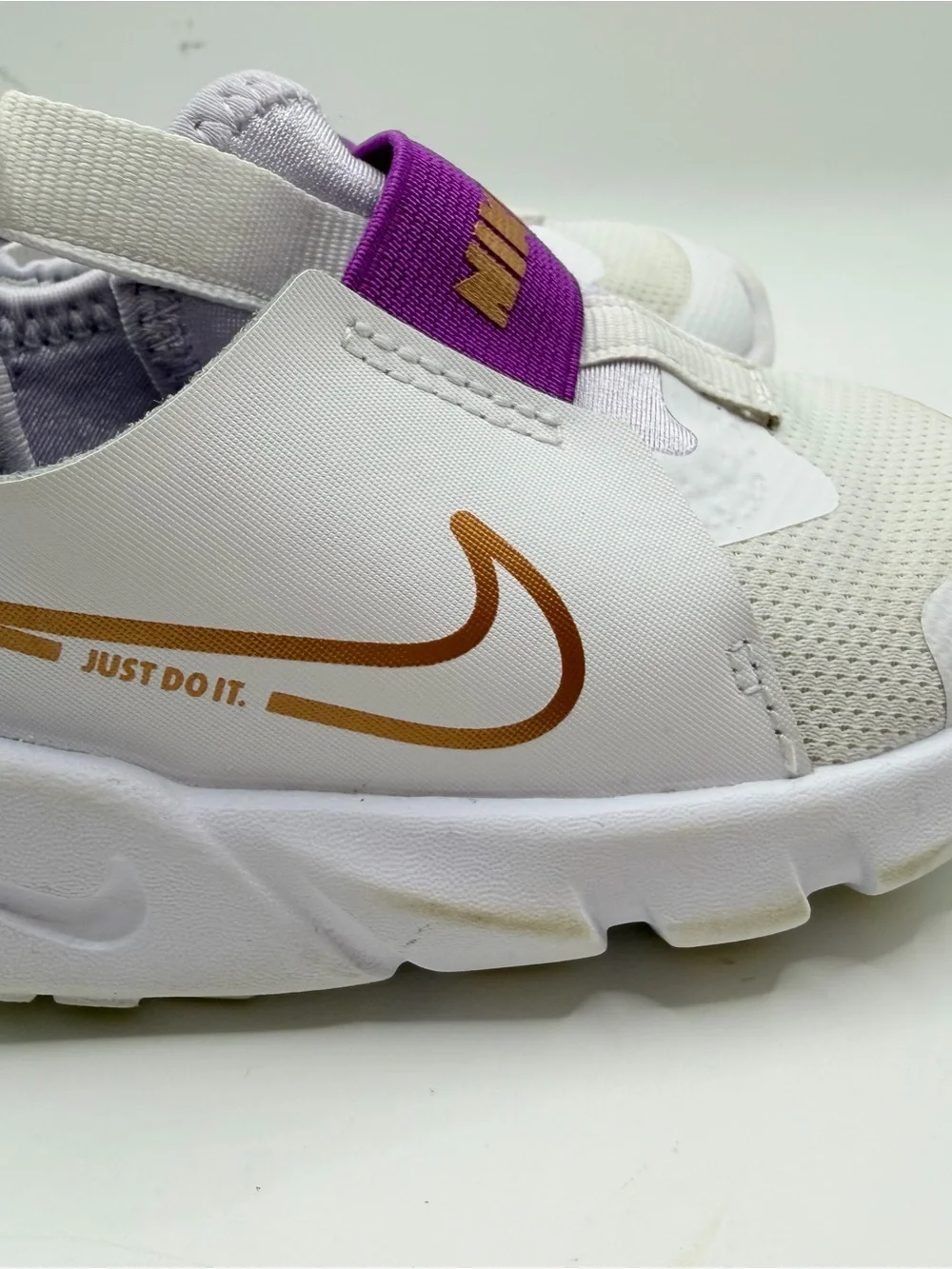 Nike Kids White Sneakers with Purple Strap and Gold Swoosh